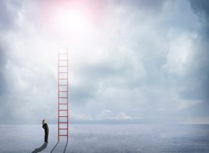 Businesswoman Looks Up At Red Ladder Extending Into The Clouds